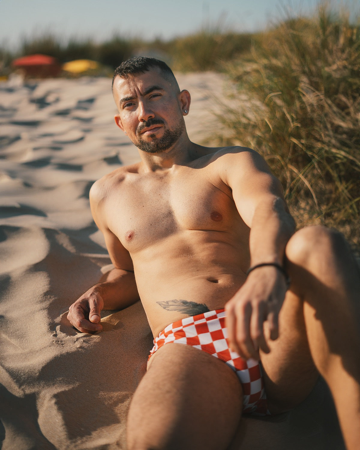 Mens Checkerboard Speedo style swim briefs, Burnt Orange checkered print swimming shorts, trendy gay swimwear by Alex Mac