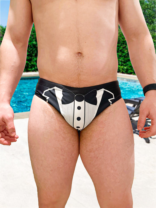 Person wearing a black and white tuxedo-themed swim suit by a pool.