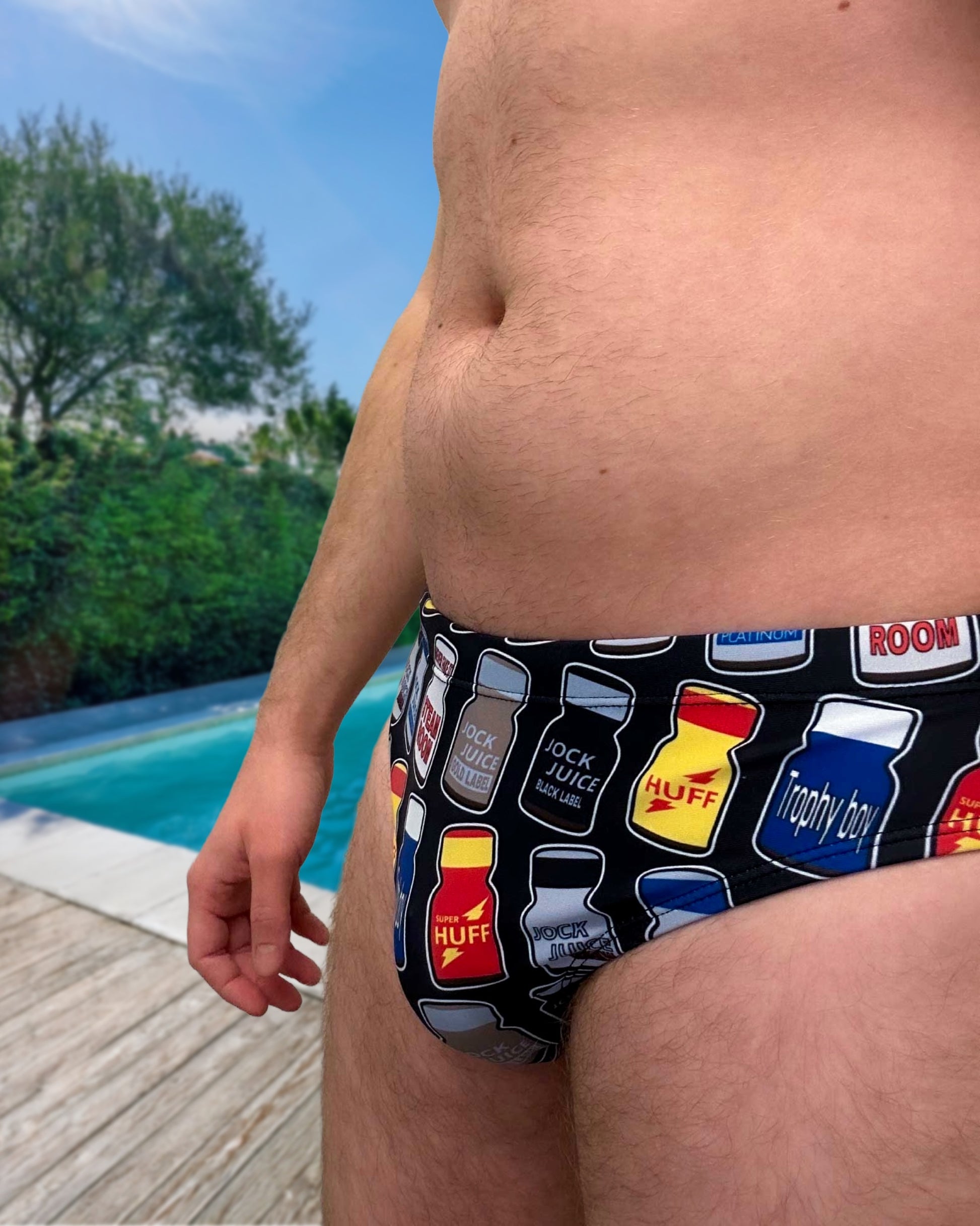 Person wearing a speedo with Poppers Logos, Rush, Jungle Juice, Blue Boy and Locker Room logos for Gay Men Swimwear by Alex Mac
