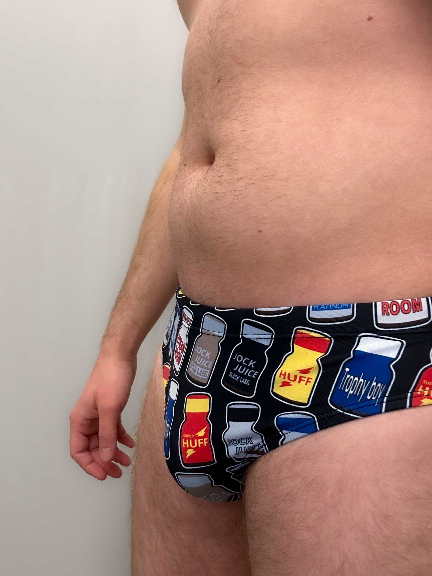 The gay mens Poppers Speedo features drawings of Rush, Double Scorpio, Blue Boy and Jungle Juice popper bottles. They’re  the perfect swim trunks for Pride, Folsom, or even cruising in the dunes at the beach ;)